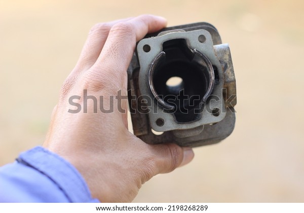 close up of a dirty hand held engine cylinder block.\
selective focus 