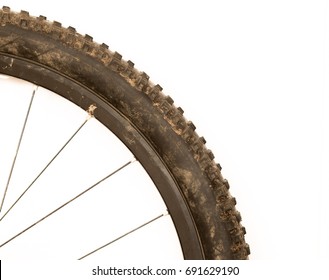 Close Up Of A Dirty Mountain Bike Tyre On A White Background On A White Background Corner