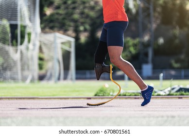 Close up disabled man athlete with leg prosthesis. Paralympic Sport Concept. - Powered by Shutterstock