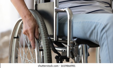 Close Up Disabled Older Woman Sitting In Wheelchair, Touching Wheels, Moving At Home Alone, Rehabilitation And Recovery After Injury, Medical Equipment, Disability And Healthcare