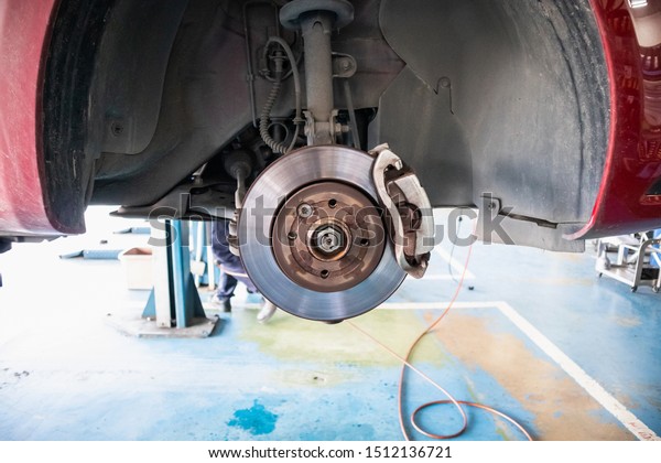 Close up disc brake\
at car service workshop