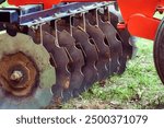 Close up of disc on a harrow on a farm.