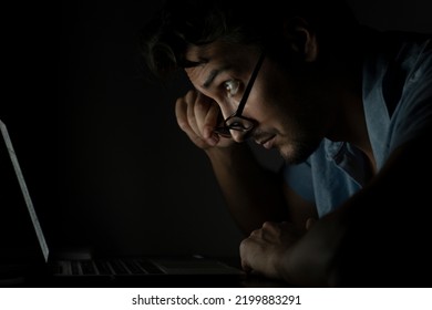 Close Up Of Disgusted Face Of Shocked Man Looking At Laptop At The Night Time	