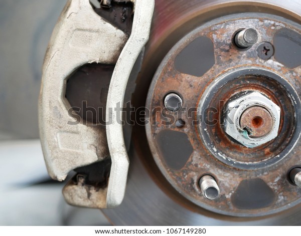 close\
up dish brake of car and maintenance car at\
garage.