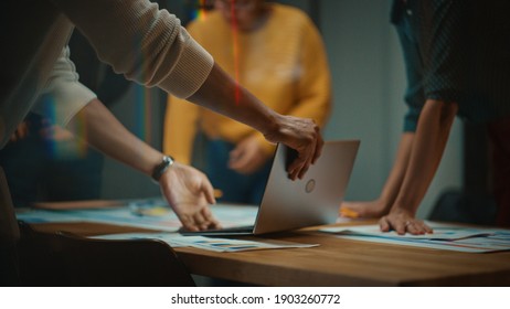Close Up of Diverse Multiethnic Team Having Conversation in Meeting Room in a Creative Office. Colleagues Lean On a Conference Table, Look at Laptop Computer and Make Notes with Pencils on Notebooks. - Shutterstock ID 1903260772