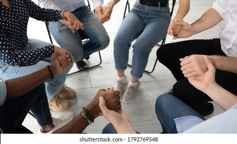 Close up diverse patients sitting on chairs in circle, holding hands, expressing support and unity at group training counselling session, psychological help and treatment concept, mental health - Powered by Shutterstock