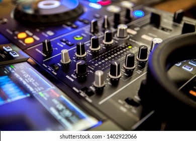 Close Up Of DJ Hands Mixing Music On A Table.