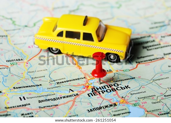 Close up of  Dnepropetrovsk  ,Ukraine , map with red\
pin and a taxi toy