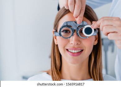 Close up of doctor checking female patient vision with trial frame at eye clinic - Powered by Shutterstock