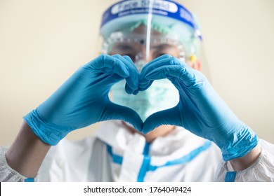 Close Up Of Doctor Hand With Personal Protective Equipment (PPE) Suit, Medical Face Mask, Face Shield And Goggle 