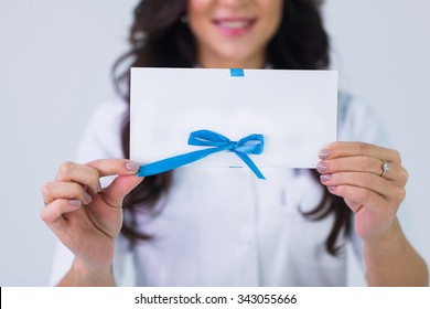 Close Up Of Doctor Holding Blank White Gift Card