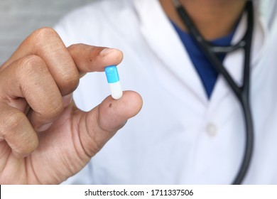 Close Up Of Doctor Holding Pills In Hand.