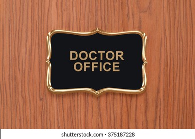 Close Up Of Doctor Office Sign On Wood Door