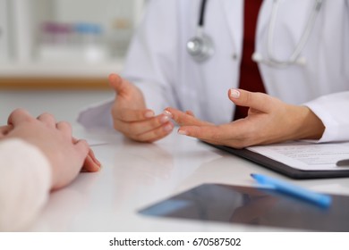 Close up of a doctor and patient hands while discussing medical records after health  examination - Shutterstock ID 670587502