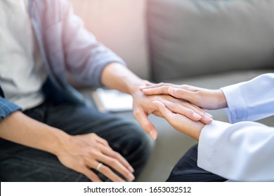 close up of doctor and patient holding hand, female doctor hands coupling the patients hand in comfort on bad news of relatives or positive testing on illness and diseases in hospital or clinic office - Shutterstock ID 1653032512