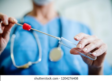 Close up of doctor with sample from sick woman. Selective focus on sample.