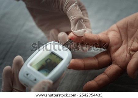 close up doctor using glucometer checking blood sugar level of senior woman. diabetes concept