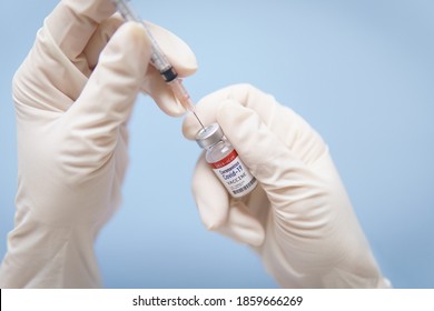 Close Up Of Doctor's Hands In Medical Latex Gloves Takes Shot From Coronavirus Vaccine Vial By Sterile Needle Syringe. Covid-19, 2019-nCoV Vaccination Development Phase 3 Concept. Authorized FDA, WHO.