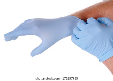 Close Up Of Doctors Hands Putting On Nitrile Gloves Isolated Over White