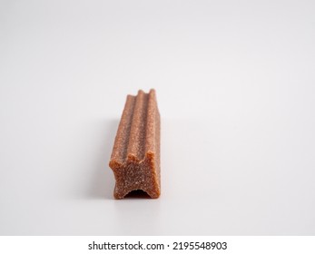 Close Up Dog Tooth Stick To Reduce Tartar Buildup Isolated On White. Canine Dental Sticks.