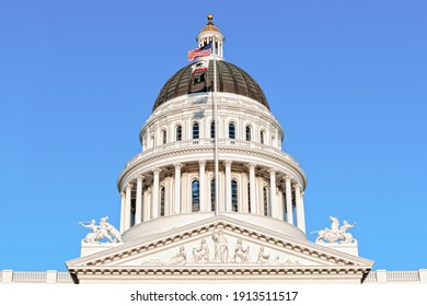Close up of the dome of the California State Capitol building during a sunny day set against a clear blue sky. 