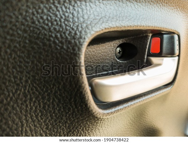 Close up of\
door lock of a car, unlocked,\
inside.
