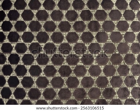 Close up of dotted hexagon pattern fabric in grey and dark purple color. Hexagonal repeated shape pattern, forming dots seamless background.