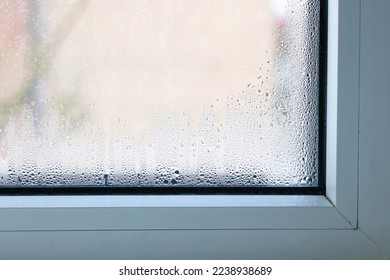 Close up of double glazed window  condensation causes by excessive moisture in the house in winter occurs when the seal between panes is broken or desiccant inside the window.