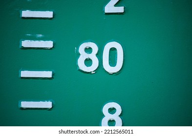 Close Up Of The Draught Marks On A Green Ship's Hull, Focussing On The Number 80