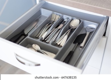 close up of drawer with cutlery in modern kitchen