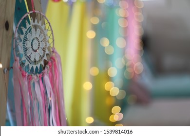 A close up of a dream catcher on teepees at a girls sleepover party. 