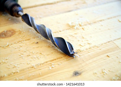 Close Up Of A Drill Bit On A Wooden Table And Keyed Chuck.
Tool For Drilling Of Wood With Saw Dust Isolated On Wooden Background. 