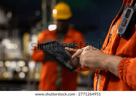 Close up of drilling barge professional analyzing equipment performance on tablet dashboard screen. Offshore platform worker monitors fossil fuel gas extraction rates and system pressure using device
