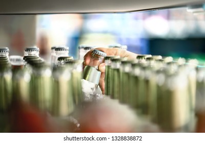 Close Up Of Drink Shelf In Supermarket. Alcohol, Soda, Sodapop, Mineral Water Or Ginger Ale Bottle. Customer Buying Product In Grocery Store Or Liquor Shop. Retail Worker Filling And Stocking Shelves.