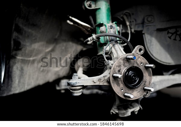 Close up Drive\
shaft of car,bearing,wheel bolt and joint of steering rack remove\
for check service work in\
Garage