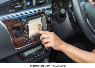 Close up driver hand press navigation screen in the car