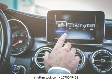 Close up of driver hand using touch screen in car. - Shutterstock ID 1070349431