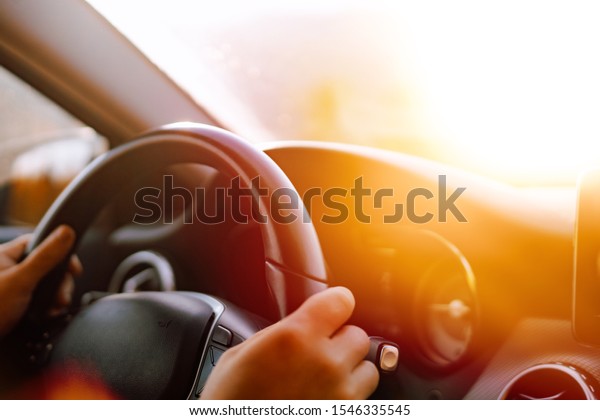 Close up of\
driver hands driving in road\
trip