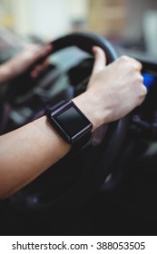 Close up of driver with smart watch in van
