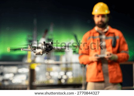 Close up of drone deployed by offshore platform worker to assess hard to reach equipment areas. Specialist flying UAV to inspect machinery components without risking human safety