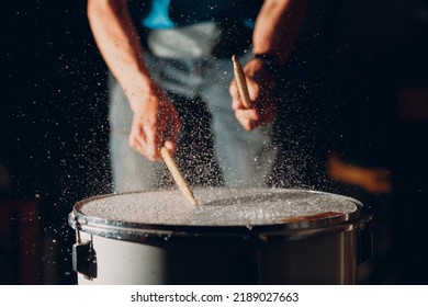 Close Up Drum Sticks Drumming Hit Beat Rhythm On Drum Surface With Splash Water Drops Falling