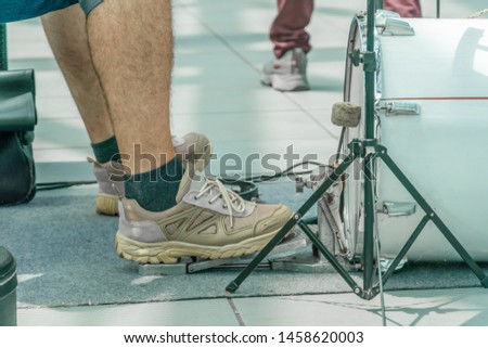 Close up drummer legs on the bass drum pedal outdoors on a sunny day