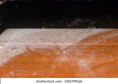 Close Up Of Dust On Wooden Table . Dusty Surface.