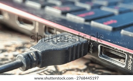 Close Up of Dusty USB Cable Plugged into Laptop Port
