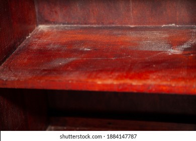 Close Up Of A Dusty Wooden Shelf In A Cabinet