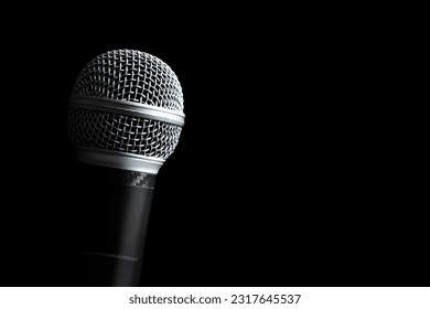Close up dynamic microphone, isolated on black. Singing, recording, broadcasting, speech concept