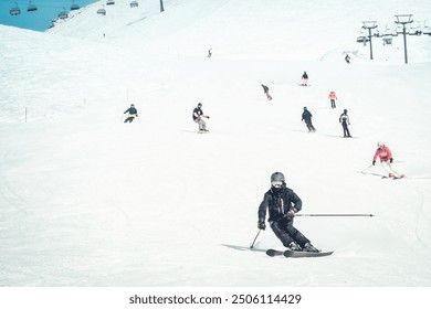 Close up dynamic sports banner of many skiers on piste ski downhill fast motion in caucasus. Active winter holidays, skiing downhill in overcast day. Ski rides on the track with swirls of fresh snow - Powered by Shutterstock