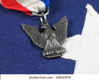 Close Up Of An Eagle Scout Award Sitting On A Flag