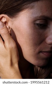 Close Up Of A Woman’s Ear With Multiple Earrings