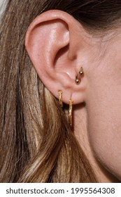 Close Up Of A Woman’s Ear With Multiple Earrings